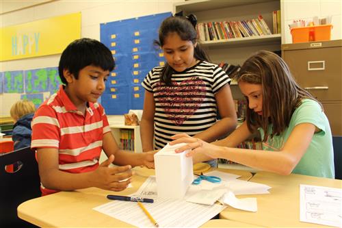 Students making a paper building