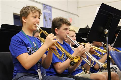 Two students playing trumpets 