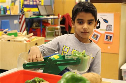 Boy weighing vegetable 